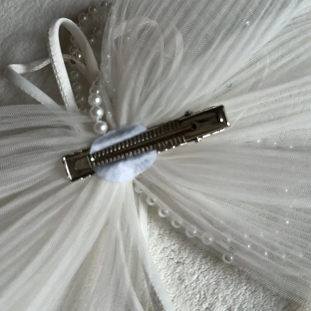 White sheer pleated bow with rhinestone and pearl embellishment
